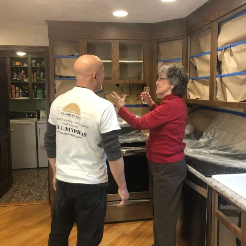 cabinet professional showing client new cabinets